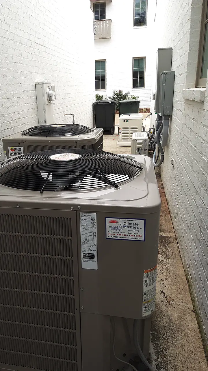 Outdoor air conditioning units by white brick building in Fairhope | Fairhope HVAC Repair